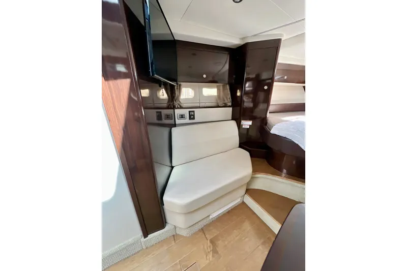 Slide: The Image of Interior of 2017 Sea Ray Sundancer 350 Coupe with seating and wood accents. - 99