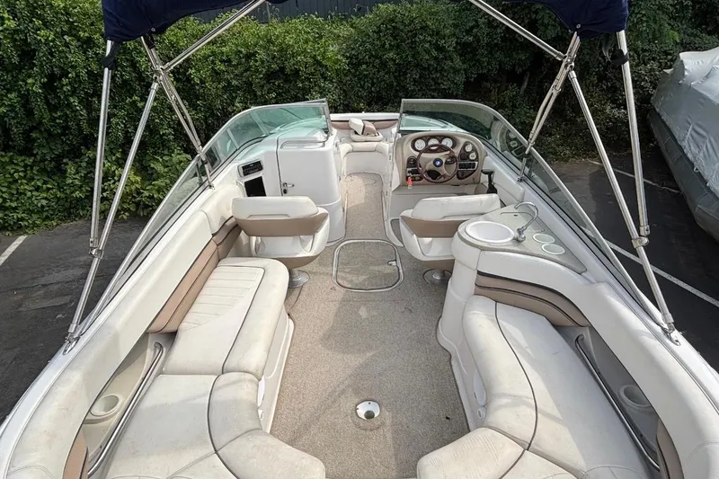 Slide: The Image of 2005 Four Winns 250 Horizon boat interior with seating, steering wheel, and canopy. - 4