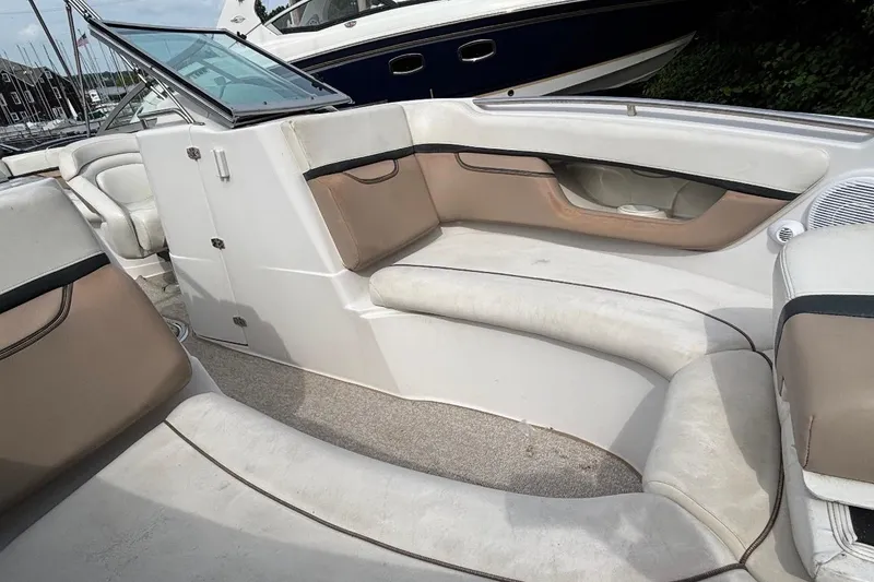 Slide: The Image of 2005 Four Winns 250 Horizon boat interior with beige seating and carpeted floor. - 5