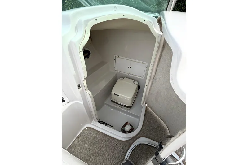 Slide: The Image of 2005 Four Winns 250 Horizon boat interior with compact toilet compartment. - 6