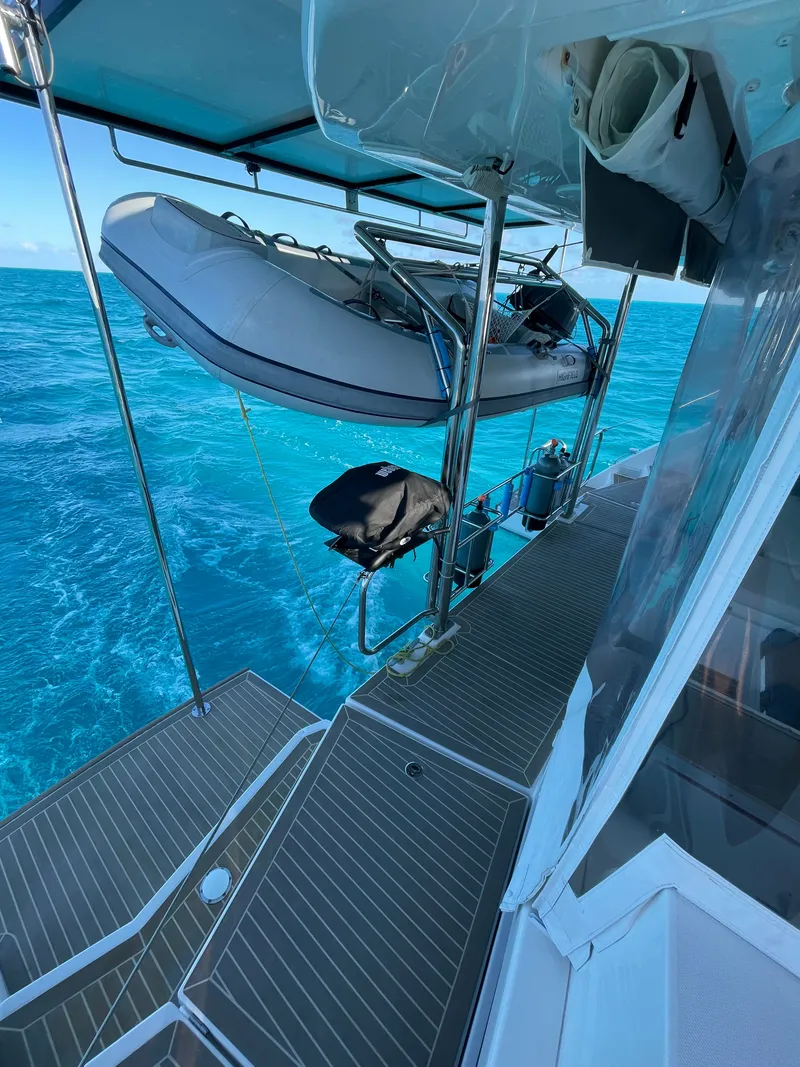 Slide: The Image of Leopard 45 catamaran with dinghy on turquoise water, year 2021. - 11