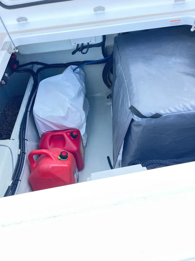 Slide: The Image of Leopard 45 boat storage compartment with canisters and covers, year 2021. - 40