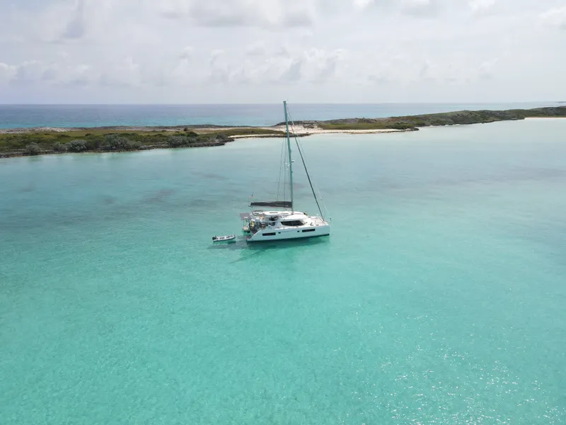 Slide: The Image of 2021 Leopard 45 catamaran in turquoise waters near an island. - 48