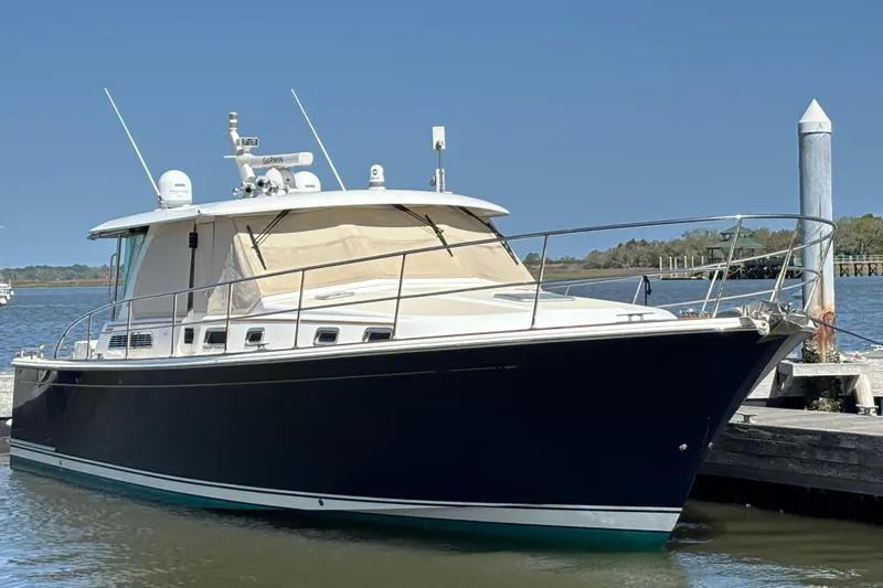 The Image of 2019 Sabre 45 Salon Express yacht docked by the water. - 0