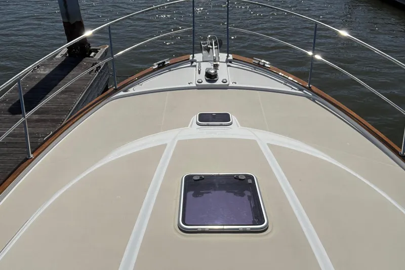 Slide: The Image of 2019 Sabre 45 Salon Express yacht deck with hatches, docked by water. - 10