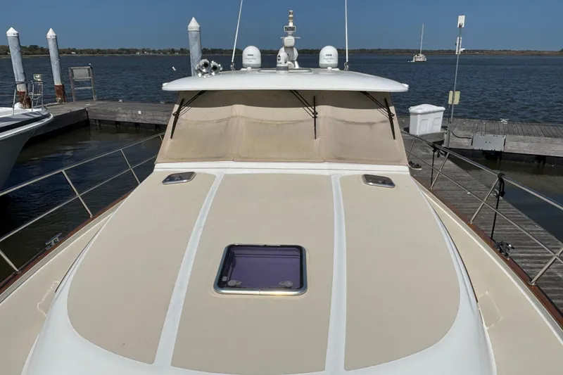 Slide: The Image of 2019 Sabre 45 Salon Express yacht docked at marina, showcasing sleek deck design. - 11
