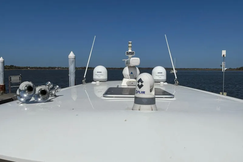Slide: The Image of 2019 Sabre 45 Salon Express yacht deck with navigation equipment and clear blue sky. - 13