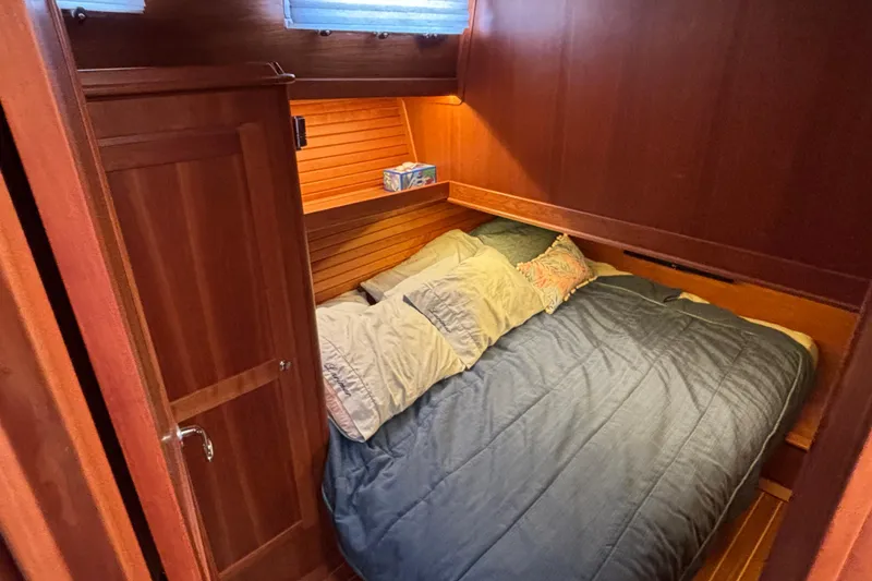 Slide: The Image of Cozy cabin interior of 2019 Sabre 45 Salon Express with wooden finish and comfortable bedding. - 21