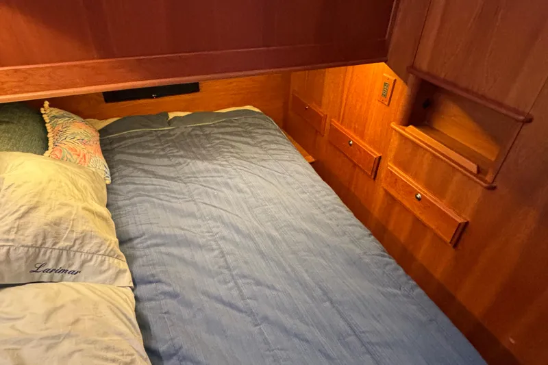 Slide: The Image of Cozy cabin bedroom in 2019 Sabre 45 Salon Express yacht with wooden interior. - 22
