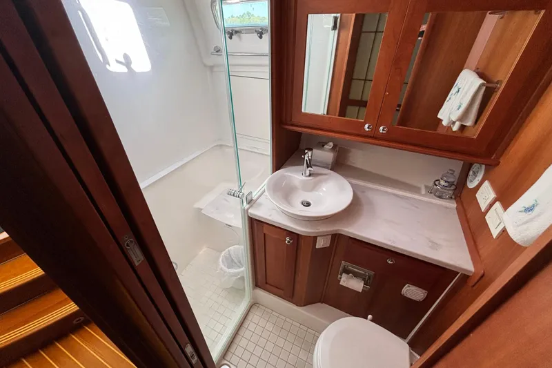Slide: The Image of Luxurious bathroom in 2019 Sabre 45 Salon Express yacht with modern fixtures and wooden cabinetry. - 24