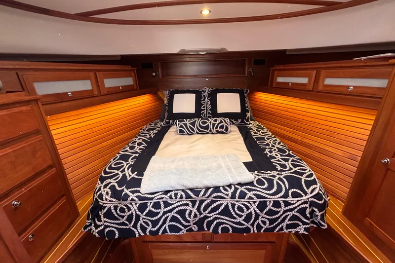 Slide: The Image of Luxurious cabin interior of 2019 Sabre 45 Salon Express with elegant bedding and warm lighting. - 28