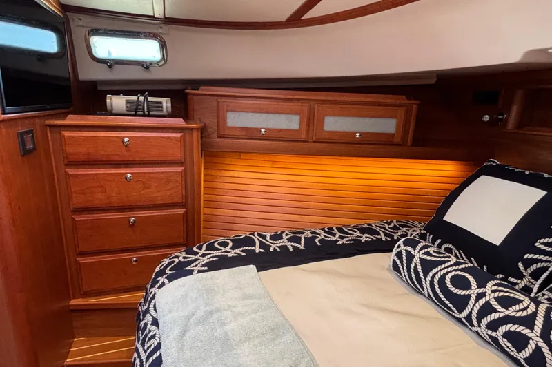 Slide: The Image of Luxurious 2019 Sabre 45 Salon Express cabin with elegant wood cabinetry and cozy bedding. - 29