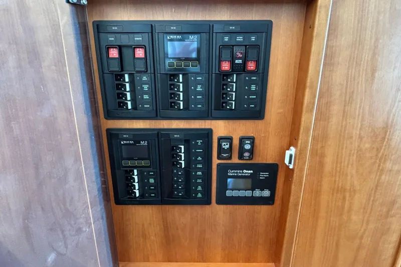 Slide: The Image of Electrical panel of 2019 Sabre 45 Salon Express yacht with Cummins Onan generator controls. - 31