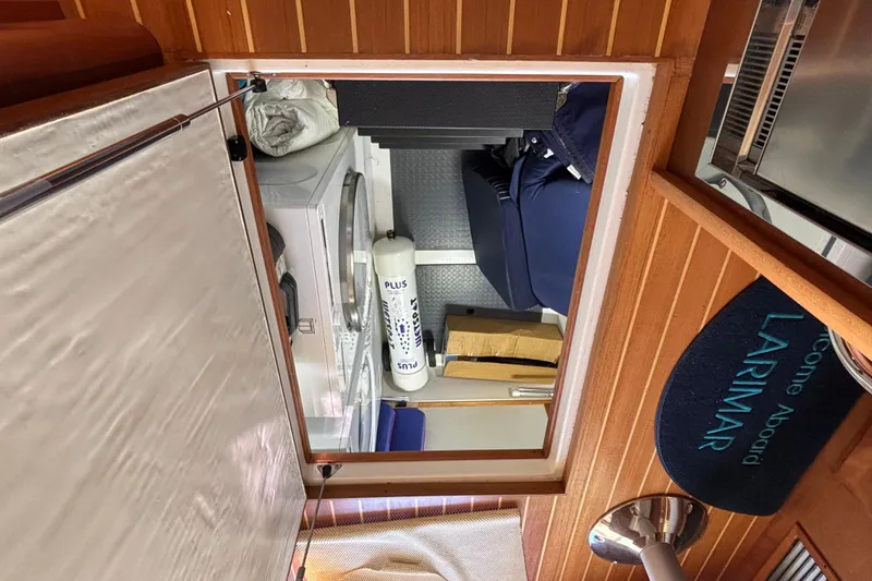 Slide: The Image of Interior view of 2019 Sabre 45 Salon Express yacht with laundry area and welcome mat. - 32