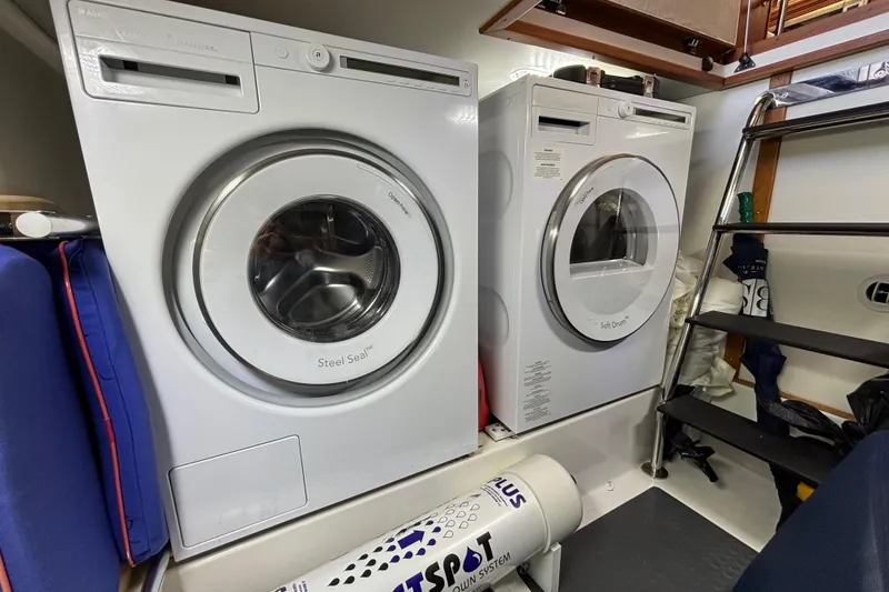 Slide: The Image of Laundry area with washer and dryer inside a 2019 Sabre 45 Salon Express yacht. - 34
