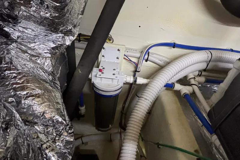 Slide: The Image of Engine room of 2019 Sabre 45 Salon Express with plumbing and insulation. - 40