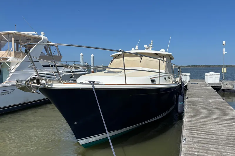 Slide: The Image of 2019 Sabre 45 Salon Express yacht docked at marina under clear blue sky. - 5