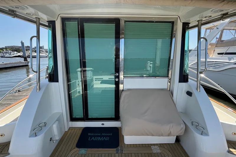 Slide: The Image of 2019 Sabre 45 Salon Express yacht stern with glass doors and seating area. - 6