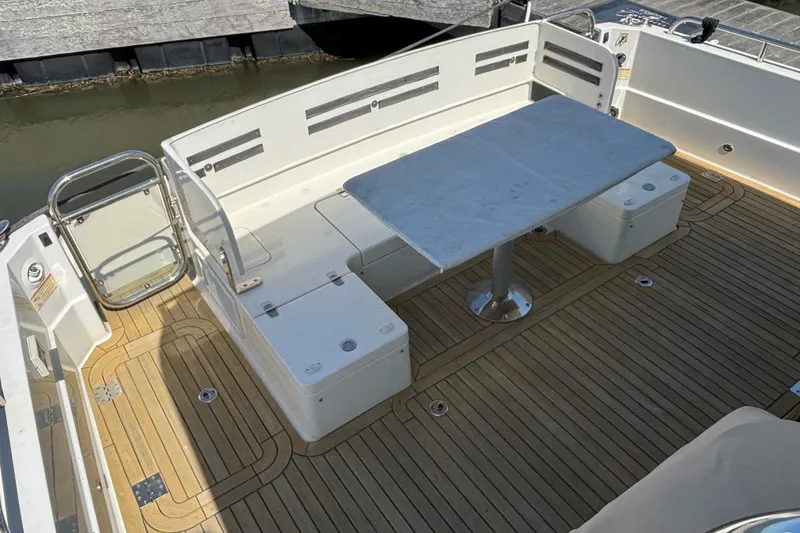 Slide: The Image of 2019 Sabre 45 Salon Express yacht deck with seating and table. - 8