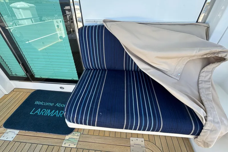Slide: The Image of Blue striped seat on 2019 Sabre 45 Salon Express yacht with welcome mat. - 9