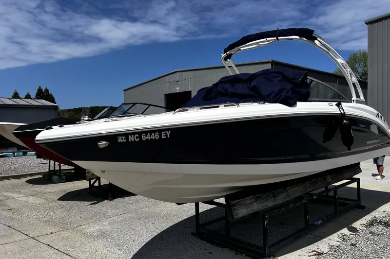 The Image of 2022 Chaparral 23 SSi boat on display outdoors, with clear blue sky background. - 1