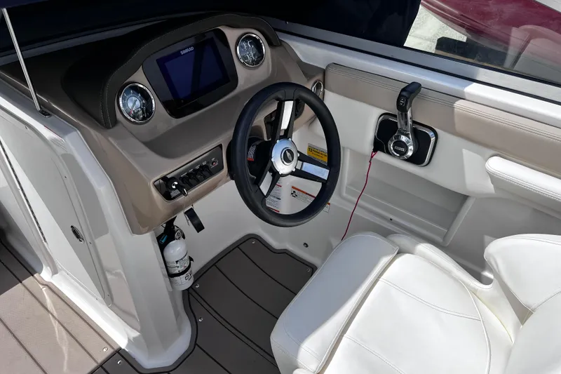 Slide: The Image of 2022 Chaparral 23 SSi boat cockpit with steering wheel and control panel. - 10