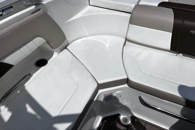 Slide: The Image of 2022 Chaparral 23 SSi boat interior with white and beige seating. - 12