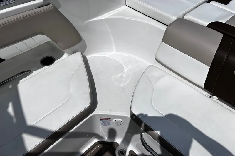 Slide: The Image of Interior seating of 2022 Chaparral 23 SSi boat, featuring white and beige upholstery. - 13