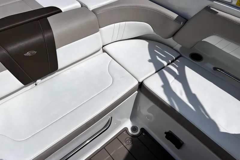 Slide: The Image of 2022 Chaparral 23 SSi boat interior with white and brown seating. - 14