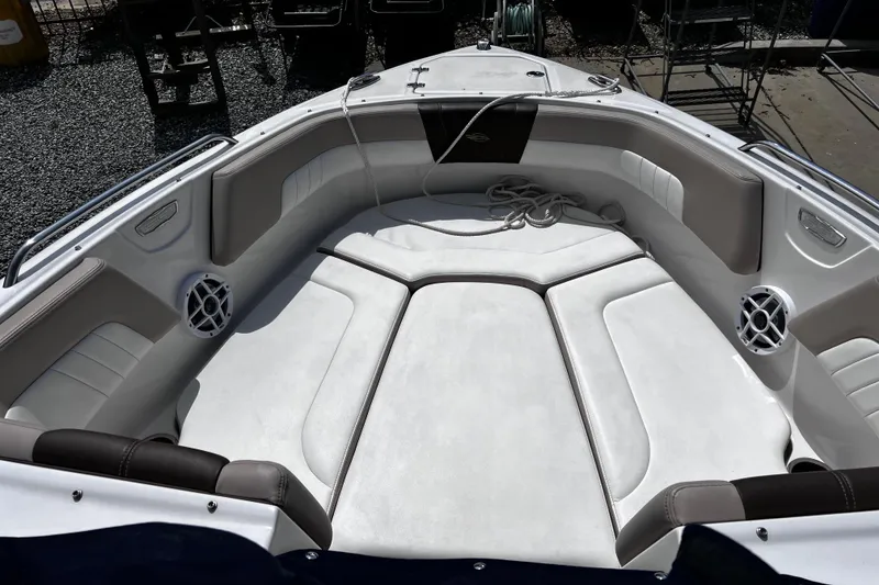 Slide: The Image of 2022 Chaparral 23 SSi boat interior with cushioned seating and speakers. - 15