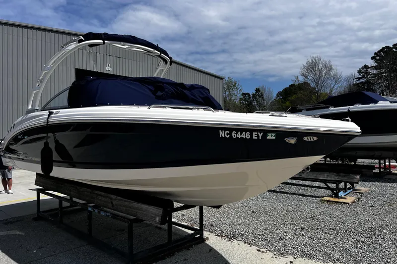 Slide: The Image of 2022 Chaparral 23 SSi boat on display, featuring sleek design and dark hull. - 3