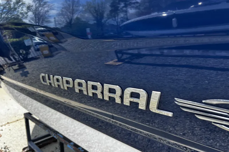 Slide: The Image of 2022 Chaparral 23 SSi boat with sleek blue exterior and logo detail. - 7