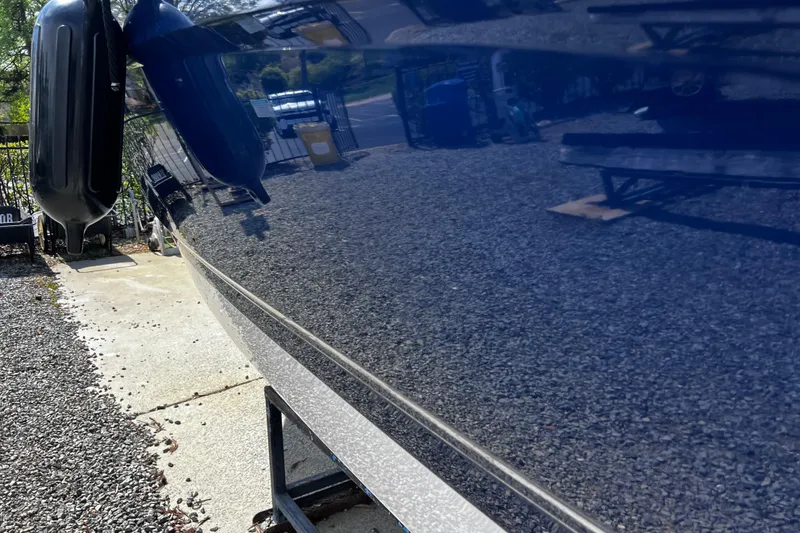 Slide: The Image of 2022 Chaparral 23 SSi boat hull with glossy finish reflecting surroundings. - 8