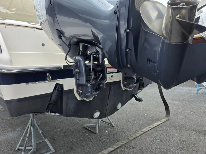 Slide: The Image of A 2017 Pursuit DC 265 Dual Console with an outboard motor on a stand. - 28