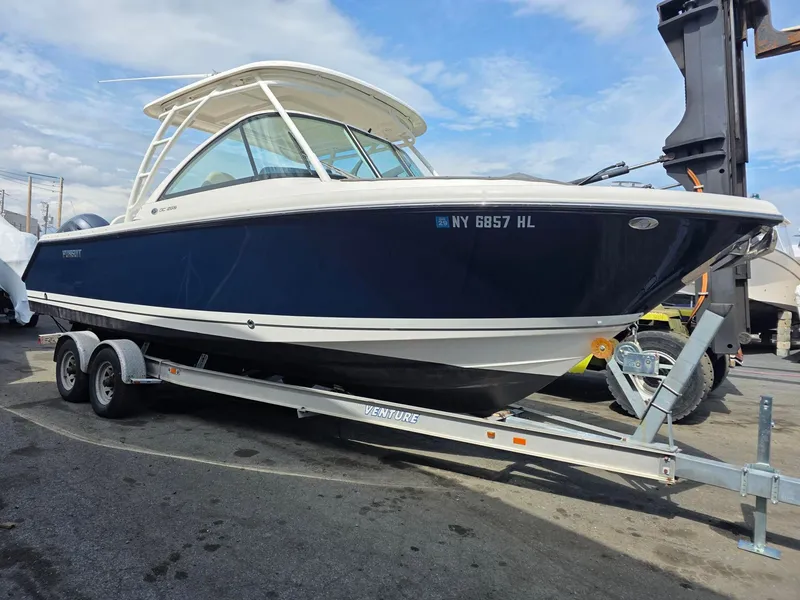 Slide: The Image of 2017 Pursuit DC 265 Dual Console boat on trailer. - 2