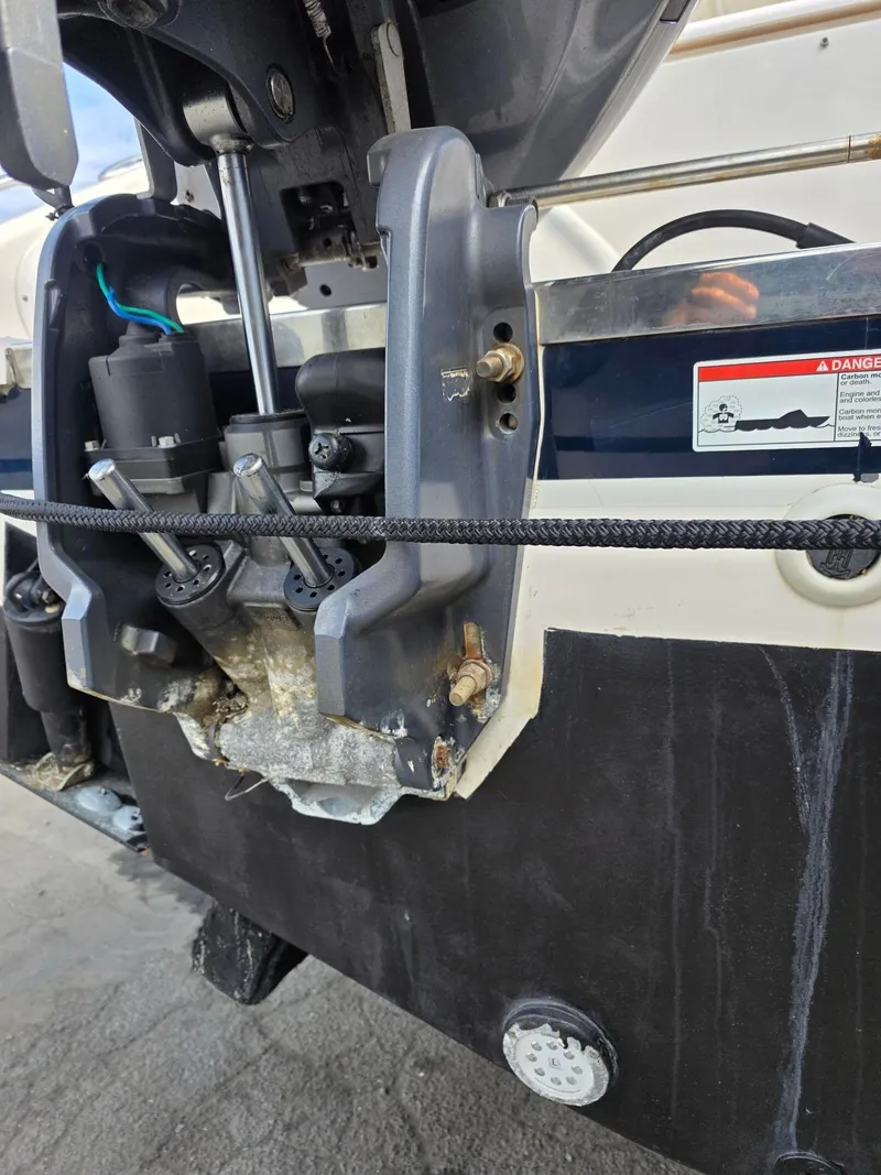 Slide: The Image of Close-up of a 2017 Pursuit DC 265 Dual Console boat engine. - 6