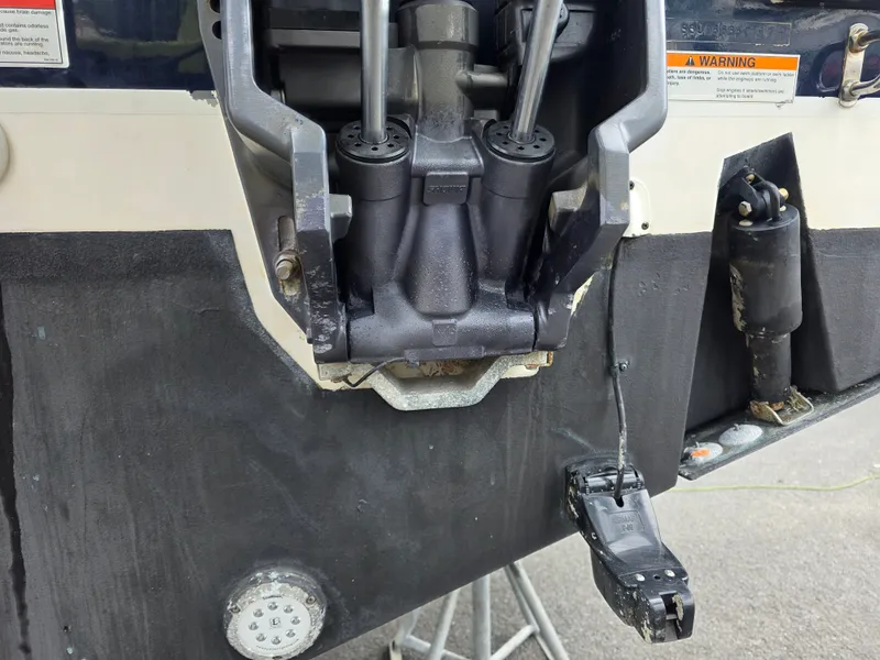 Slide: The Image of Close-up of the outboard motor on a 2017 Pursuit DC 265 Dual Console boat. - 30