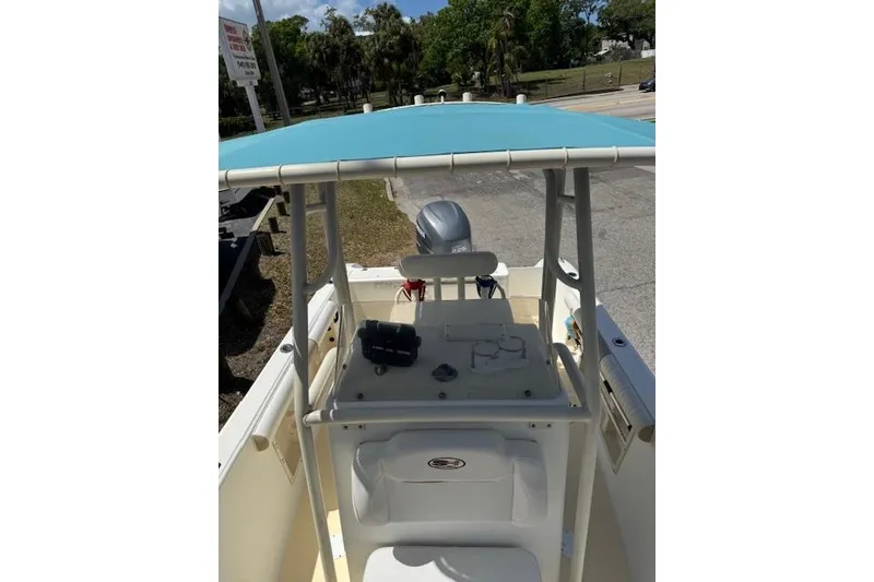 Slide: The Image of 2003 Sea Fox 230 Center Console boat with blue canopy and console view. - 10