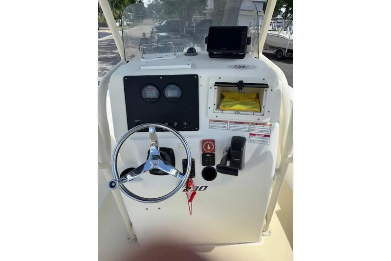 Slide: The Image of Console of a 2003 Sea Fox 230 Center Console boat with steering wheel and gauges. - 13