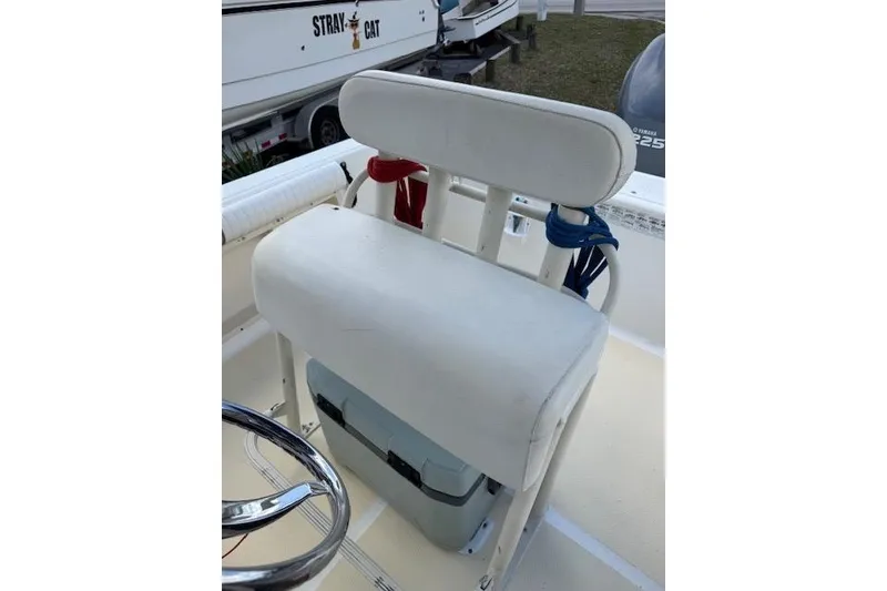 Slide: The Image of 2003 Sea Fox 230 Center Console boat seat with storage and steering wheel. - 15