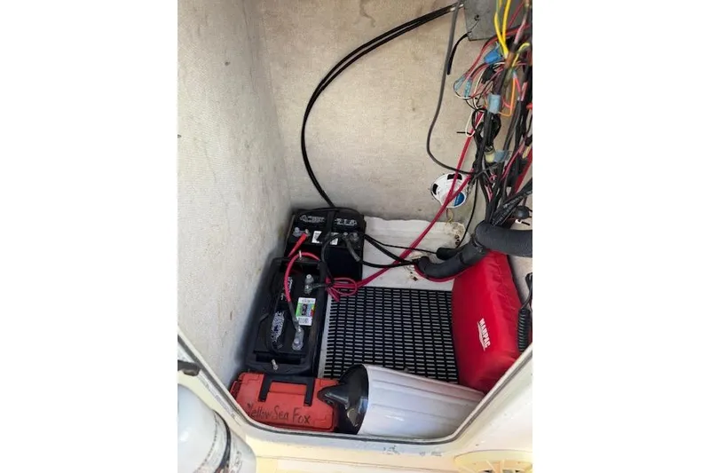 Slide: The Image of Electrical compartment of a 2003 Sea Fox 230 Center Console boat with batteries and wiring. - 19