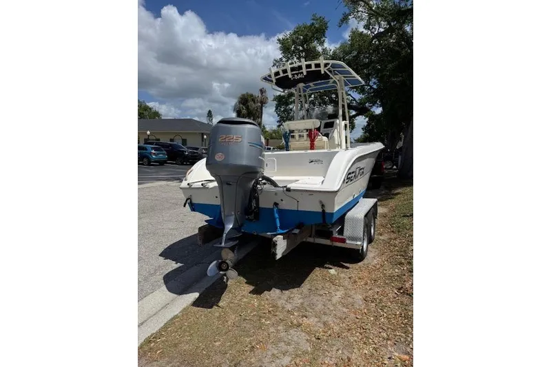 Slide: The Image of 2003 Sea Fox 230 Center Console boat on trailer, featuring a 225 HP outboard motor. - 3