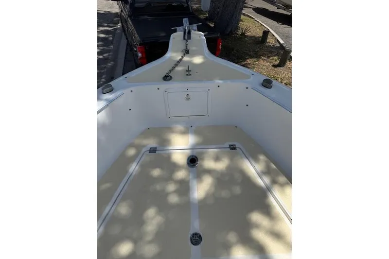 Slide: The Image of 2003 Sea Fox 230 Center Console boat deck with anchor chain and storage compartments. - 6