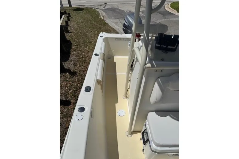 Slide: The Image of 2003 Sea Fox 230 Center Console boat interior with seating and storage. - 8