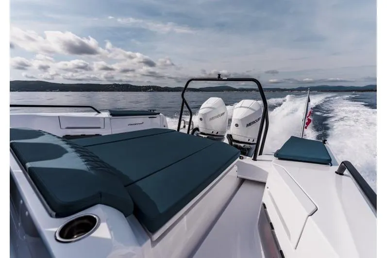 Slide: The Image of 2027 Axopar 37 Spyder cruising on open water with twin Mercury engines. - 2