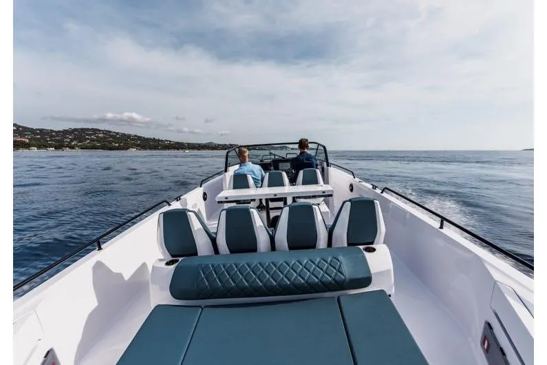 Slide: The Image of 2027 Axopar 37 Spyder cruising on open water with two passengers. - 4