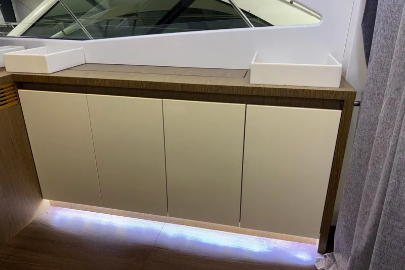 The Image of Interior of 2014 Beneteau Gran Turismo 49 yacht with modern cabinetry and ambient lighting. - 1