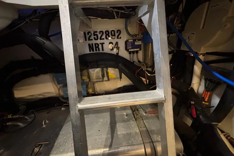 Slide: The Image of Engine room of a 2014 Beneteau Gran Turismo 49 yacht with visible ladder and equipment. - 22