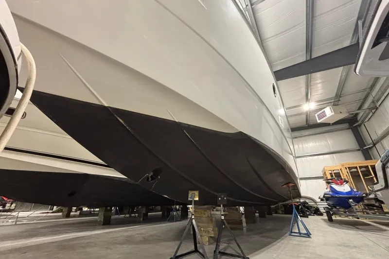 Slide: The Image of 2014 Beneteau Gran Turismo 49 yacht in storage, showcasing sleek hull design. - 27