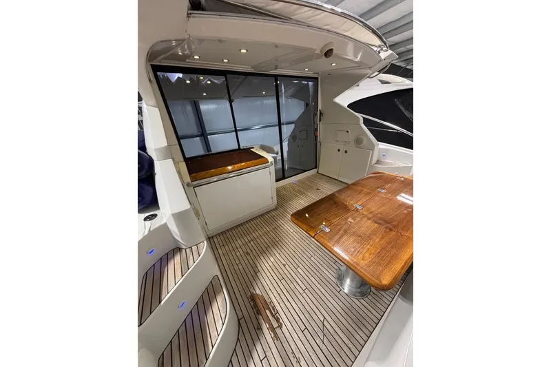 Slide: The Image of 2014 Beneteau Gran Turismo 49 yacht interior with wooden table and sleek design. - 4